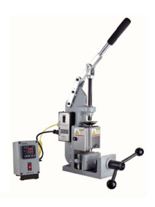 The Model B-100 is a manually operated tabletop plastic injection molding machine.